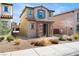 Charming two-story home showcasing stone accents, low maintenance landscaping, and a tiled roof at 1023 Brilliant Meadow Ave, North Las Vegas, NV 89086