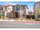 Charming two-story home showcasing stone accents, low maintenance landscaping, and a tiled roof at 1023 Brilliant Meadow Ave, North Las Vegas, NV 89086
