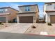Featuring a spacious two-car garage with a paved driveway and drought tolerant landscaping at 1023 Brilliant Meadow Ave, North Las Vegas, NV 89086