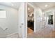 Upstairs hallway near the laundry room featuring carpet floors, lighting and white doors at 1023 Brilliant Meadow Ave, North Las Vegas, NV 89086