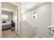 Hallway with a view of the bedroom and stairs, featuring neutral tones and natural light at 1023 Brilliant Meadow Ave, North Las Vegas, NV 89086