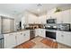 Modern kitchen with stainless steel appliances, granite countertops and stylish white cabinets at 1023 Brilliant Meadow Ave, North Las Vegas, NV 89086