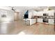 Bright, open-concept living space featuring wood-look flooring, an open kitchen, and natural light at 1023 Brilliant Meadow Ave, North Las Vegas, NV 89086