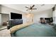 Spacious main bedroom with a large bed, TV, ceiling fan and access to ensuite at 1023 Brilliant Meadow Ave, North Las Vegas, NV 89086
