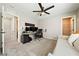 Neutral-toned office featuring carpet, ceiling fan, and workstation with monitors and accessories at 1023 Brilliant Meadow Ave, North Las Vegas, NV 89086