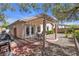 Backyard patio with pergola cover, outdoor dining area, and a grill at 10791 Silver Lace Ln, Las Vegas, NV 89135