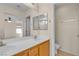 The bathroom features double sinks, a large mirror, and a view into a bedroom at 10791 Silver Lace Ln, Las Vegas, NV 89135