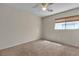 Neutral bedroom featuring a ceiling fan and a window with blinds at 10791 Silver Lace Ln, Las Vegas, NV 89135