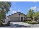 Single-story home featuring a two-car garage and landscaped yard at 10791 Silver Lace Ln, Las Vegas, NV 89135