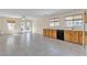 Open-concept kitchen with stainless steel appliances, and tile flooring, extending to a dining area with backyard access at 10791 Silver Lace Ln, Las Vegas, NV 89135