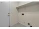 Bright laundry room with tile flooring, upper shelf, and utility connections at 10791 Silver Lace Ln, Las Vegas, NV 89135