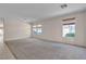Spacious living room features neutral carpet and natural light from several windows at 10791 Silver Lace Ln, Las Vegas, NV 89135