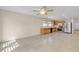 Open living space merging living and kitchen areas, tile floors, wood cabinets, and stainless appliances at 10791 Silver Lace Ln, Las Vegas, NV 89135