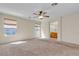 Spacious main bedroom with carpet, ceiling fan, windows, and a glimpse into an attached bathroom at 10791 Silver Lace Ln, Las Vegas, NV 89135