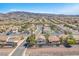 Wide aerial view of a neighborhood featuring tree-lined streets and various home styles at 1088 Casady Hollow Ave, Henderson, NV 89012