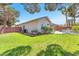 Spacious backyard features lush green grass, mature trees, and a charming patio area at 1088 Casady Hollow Ave, Henderson, NV 89012