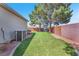 Large backyard showcasing a well-maintained lawn, privacy fence, and mature trees at 1088 Casady Hollow Ave, Henderson, NV 89012