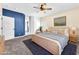 This staged bedroom has a ceiling fan, carpet and a bed at 1088 Casady Hollow Ave, Henderson, NV 89012
