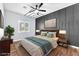 The staged bedroom features a ceiling fan and wood floors at 1088 Casady Hollow Ave, Henderson, NV 89012
