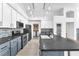Bright kitchen with two-tone cabinetry, granite counters, stainless appliances and stylish pendant lighting at 1088 Casady Hollow Ave, Henderson, NV 89012