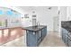 Bright kitchen with two-tone cabinetry, granite counters, stainless appliances and stylish pendant lighting at 1088 Casady Hollow Ave, Henderson, NV 89012