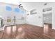 Bright living room featuring hardwood floors, tall windows, a ceiling fan and a fireplace at 1088 Casady Hollow Ave, Henderson, NV 89012
