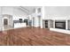 Bright, open-concept living room with new flooring, fireplace, and kitchen view at 1088 Casady Hollow Ave, Henderson, NV 89012