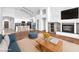 Open-concept living room with a modern fireplace and a view into the bright kitchen at 1088 Casady Hollow Ave, Henderson, NV 89012