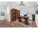 Office with built-in bookcase, hardwood floors, stylish desk and a ceiling fan at 1088 Casady Hollow Ave, Henderson, NV 89012