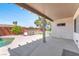 Covered patio adjacent to pool features outdoor seating and a tranquil view of the yard at 1088 Casady Hollow Ave, Henderson, NV 89012