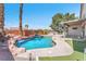 Backyard oasis with a stunning rock waterfall, surrounded by lush landscaping and a pool at 1088 Casady Hollow Ave, Henderson, NV 89012