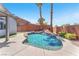 Sparkling pool features a rock waterfall, set in a private backyard oasis with mature palms at 1088 Casady Hollow Ave, Henderson, NV 89012