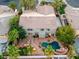 Aerial view of a home with a pool, spa, outdoor kitchen, patio, and mature landscaping at 11158 Antonine Wall Ct, Las Vegas, NV 89141