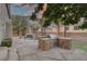 Outdoor kitchen, custom pool with rock waterfall, and palm trees create an ideal entertaining space in the backyard at 11158 Antonine Wall Ct, Las Vegas, NV 89141