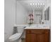 This bathroom features a large mirror with vanity lighting and wooden cabinets at 11158 Antonine Wall Ct, Las Vegas, NV 89141