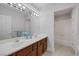 Bathroom featuring double sinks, wood cabinets, and a shower-tub combo at 11158 Antonine Wall Ct, Las Vegas, NV 89141