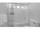 Bathroom with a combined tub and shower featuring white tile and modern fixtures at 11158 Antonine Wall Ct, Las Vegas, NV 89141