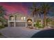 Stunning two-story home showcasing meticulously landscaped grounds and a grand paver driveway at 11158 Antonine Wall Ct, Las Vegas, NV 89141