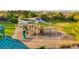Community playground with slides, climbing structures, and shade covers, set in a spacious green area with trees at 11158 Antonine Wall Ct, Las Vegas, NV 89141
