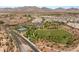 An aerial view of a vibrant community with parks, tennis courts, and meticulously landscaped green spaces at 11398 Belmont Lake Dr # 104, Las Vegas, NV 89135