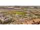 An aerial view showcasing a well-maintained community park with green space, tennis courts, and picnic areas at 11398 Belmont Lake Dr # 104, Las Vegas, NV 89135