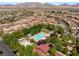 Aerial view of a community pool with lounge chairs and shade structures nestled amongst mature trees and landscaping at 11398 Belmont Lake Dr # 104, Las Vegas, NV 89135