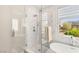 Glass shower with marble walls and tile floor at 11398 Belmont Lake Dr # 104, Las Vegas, NV 89135