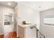 Upstairs hallway featuring wood floors, custom cabinetry, and a view of the bedroom at 11398 Belmont Lake Dr # 104, Las Vegas, NV 89135