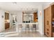 Open-concept kitchen boasts a breakfast bar with sleek stools and modern lighting fixtures at 11398 Belmont Lake Dr # 104, Las Vegas, NV 89135