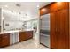 Spacious kitchen with stainless steel appliances and wood cabinets, seamlessly connected to the living area at 11398 Belmont Lake Dr # 104, Las Vegas, NV 89135