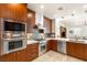 Well-equipped kitchen featuring stainless steel appliances, custom cabinetry, and a modern backsplash at 11398 Belmont Lake Dr # 104, Las Vegas, NV 89135