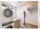 Modern laundry room featuring stacked washer and dryer and custom storage at 11398 Belmont Lake Dr # 104, Las Vegas, NV 89135