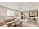 Open-concept living room with modern furnishings and seamless flow to the adjacent kitchen area at 11398 Belmont Lake Dr # 104, Las Vegas, NV 89135