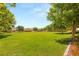 Lush green park area with mature trees, offering a tranquil setting for relaxation and outdoor enjoyment at 11398 Belmont Lake Dr # 104, Las Vegas, NV 89135